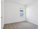 Carpeted bedroom with one window allowing in natural light at 1912 Archer Dr, Minneola, FL 34715