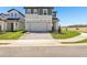 Charming two-story home with a two car garage, brick paver driveway and a well manicured lawn at 1912 Archer Dr, Minneola, FL 34715