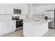 Modern kitchen with white cabinets, stainless steel appliances, and large center island at 1912 Archer Dr, Minneola, FL 34715