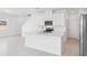 Kitchen island with stainless steel appliances and sleek white cabinets at 1912 Archer Dr, Minneola, FL 34715
