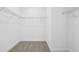 Spacious walk-in closet with carpet floors and metal shelving for ample storage at 1912 Archer Dr, Minneola, FL 34715