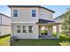Back exterior showing a covered patio and a lush green lawn at 2236 Hen Rd, Minneola, FL 34715