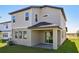 Rear exterior with a covered patio and an expansive lawn at 2236 Hen Rd, Minneola, FL 34715