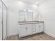 Bright bathroom showcasing a double vanity with granite countertops and a spacious shower at 2236 Hen Rd, Minneola, FL 34715