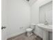 Bathroom featuring tile floors, a white sink, toilet and mirror at 2236 Hen Rd, Minneola, FL 34715