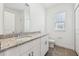 Bathroom with granite vanity, window, tile floors, toilet, and walk-in shower at 2236 Hen Rd, Minneola, FL 34715
