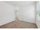 Neutral bedroom featuring carpet, doors, and a window bringing in natural light at 2236 Hen Rd, Minneola, FL 34715