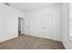 Neutral bedroom featuring carpet, doors, and a window with natural light at 2236 Hen Rd, Minneola, FL 34715