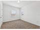 Bright bedroom featuring neutral walls, carpet, and window bringing in natural light at 2236 Hen Rd, Minneola, FL 34715