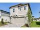 Charming two-story home with a neatly paved driveway and attached two-car garage, nestled in a well-manicured lawn at 2236 Hen Rd, Minneola, FL 34715