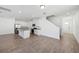 Open-concept kitchen featuring white cabinets, stainless steel appliances, and granite countertops at 2236 Hen Rd, Minneola, FL 34715