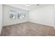 Bright, airy living room with neutral tile flooring and ample natural light from large windows at 2236 Hen Rd, Minneola, FL 34715