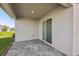 A covered patio featuring brick pavers and a sliding glass door entry into the home at 2236 Hen Rd, Minneola, FL 34715