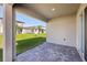 Covered patio with pavers offers a relaxing outdoor space overlooking the backyard at 2236 Hen Rd, Minneola, FL 34715