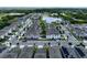 Aerial view of a community featuring a pond, gray homes and lush trees at 2252 Emerald Springs Dr, Apopka, FL 32712
