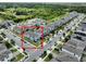 This aerial shows a lovely neighborhood of townhomes with manicured lawns near winding sidewalks and tree-lined streets at 2252 Emerald Springs Dr, Apopka, FL 32712