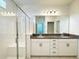 Bright bathroom features a glass shower and double vanity with granite countertops at 2252 Emerald Springs Dr, Apopka, FL 32712