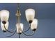 Close up of decorative chandelier with frosted shades and metal fixture at 2252 Emerald Springs Dr, Apopka, FL 32712