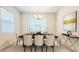 Formal dining room with stylish chandelier, elegant table setting, and artwork at 2252 Emerald Springs Dr, Apopka, FL 32712
