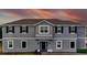 Two-story home featuring a grey exterior, well-manicured lawn, and classic window trim at 2252 Emerald Springs Dr, Apopka, FL 32712