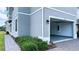 Side view of a gray home featuring a 2-car garage with green landscaping at 2252 Emerald Springs Dr, Apopka, FL 32712