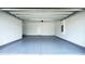 A spacious two-car garage featuring white walls and a gray epoxy floor at 2252 Emerald Springs Dr, Apopka, FL 32712