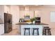 Bright kitchen with white cabinetry, stainless steel appliances, and a granite island with seating at 2252 Emerald Springs Dr, Apopka, FL 32712