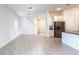 Open-concept living space featuring tile flooring, staircase, and kitchen at 2252 Emerald Springs Dr, Apopka, FL 32712