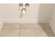 A close-up of under-sink plumbing with tile flooring and crisp, white trim at 2252 Emerald Springs Dr, Apopka, FL 32712