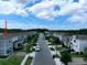 Charming townhomes lining a well-manicured street with sidewalks and lush landscaping, creating a welcoming neighborhood ambiance at 2252 Emerald Springs Dr, Apopka, FL 32712