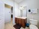 Well-organized bathroom with a vanity, mirror, wall cabinet, and tiled floors at 2530 Holtrock St, Kissimmee, FL 34747