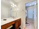 Bathroom with long vanity, dual sinks, nice lighting, and tiled floor at 2530 Holtrock St, Kissimmee, FL 34747