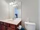 Bathroom featuring a single sink vanity, toilet, and mirror at 2530 Holtrock St, Kissimmee, FL 34747
