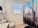 A cozy bathroom featuring a castle themed shower curtain and a window for natural light at 2530 Holtrock St, Kissimmee, FL 34747