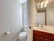 Bathroom features toilet and vanity area with sink and large mirror at 2530 Holtrock St, Kissimmee, FL 34747