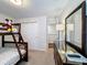 Bright bedroom featuring a bunk bed, dresser, and an ensuite bathroom at 2530 Holtrock St, Kissimmee, FL 34747