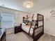 Cozy bedroom featuring a bunk bed, striped bedding, a nightstand and neutral decor at 2530 Holtrock St, Kissimmee, FL 34747