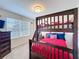 Nicely decorated bedroom featuring bunk beds, a window view, dresser, and ceiling fan at 2530 Holtrock St, Kissimmee, FL 34747