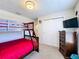 Bedroom features bunk beds, ceiling fan, TV, closet, and dresser at 2530 Holtrock St, Kissimmee, FL 34747