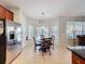 Bright dining area with tile floor, a glass table and view to the pool outside at 2530 Holtrock St, Kissimmee, FL 34747