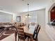 Bright dining room with an elegant table and view of the kitchen and living room at 2530 Holtrock St, Kissimmee, FL 34747