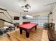 Amusement-filled game room featuring a pool table, foosball table, basketball hoops, and a TV at 2530 Holtrock St, Kissimmee, FL 34747