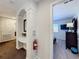 Hallway leading to the bedroom featuring a small table and a fire extinguisher at 2530 Holtrock St, Kissimmee, FL 34747
