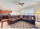 A spacious living room with brown leather sectional and a view of the kitchen and dining area at 2530 Holtrock St, Kissimmee, FL 34747