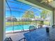 Relax poolside under the screened lanai with outdoor dining and a lush backyard view at 2530 Holtrock St, Kissimmee, FL 34747