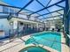 Delight in the screened-in pool and spa area, equipped with an outdoor kitchen and dining at 2530 Holtrock St, Kissimmee, FL 34747