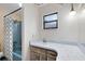 Simple bathroom with a blue bathtub, a vanity with blue trim, and a small window for natural light at 25548 Pine Valley Dr, Mount Plymouth, FL 32776