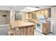 Functional kitchen with a breakfast bar, stainless steel appliances, and ample countertop space for meal preparation at 25548 Pine Valley Dr, Mount Plymouth, FL 32776