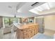 Inviting kitchen with a breakfast bar, stainless steel refrigerator, and an open view into the adjacent living area at 25548 Pine Valley Dr, Mount Plymouth, FL 32776
