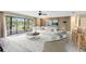 Bright living room with a large window, wood paneling, stylish furniture, and a view of the outdoors at 25548 Pine Valley Dr, Mount Plymouth, FL 32776